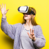 Teenage girl with virtual reality headset on yellow background